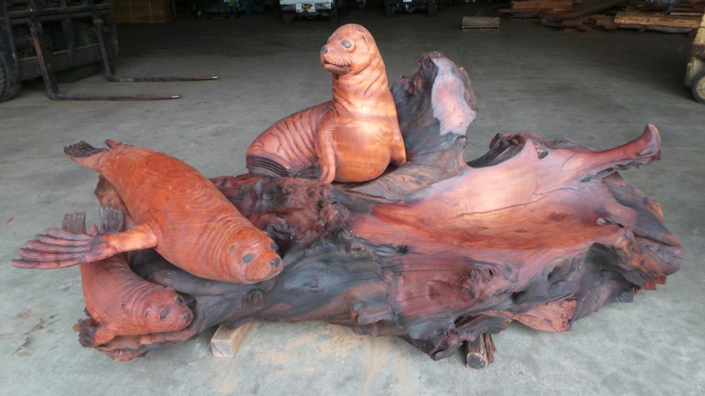 Custom burl wood bench with seal carving