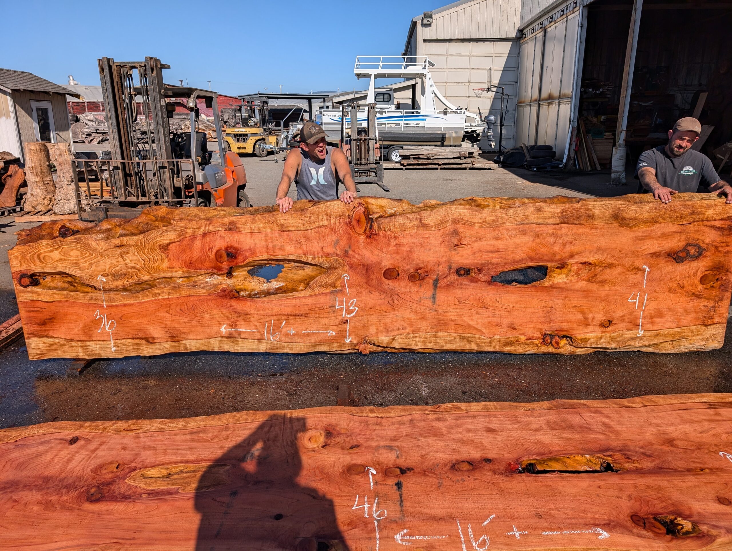 Redwood table top measuring 16 feet wide by 36 to 43 inches wide and 3 inches thick.